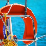 Composition with lifebuoy ring. Sailing yacht catamaran boat on turquoise waters of Aegean Sea near Athens. Yachting. Famous travel sailing destination in Europe. Sailboat.